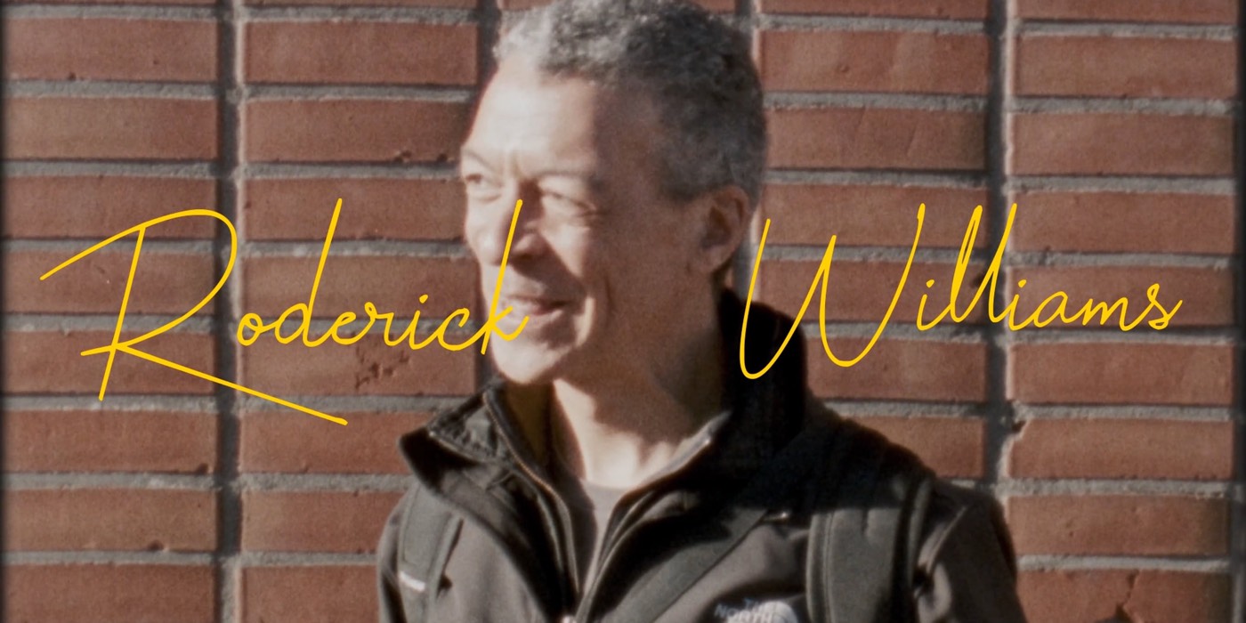 Still from doubleA tapes, episode 2: Roderick Williams in front of a brick wall, his name written across the picture in yellow handwriting