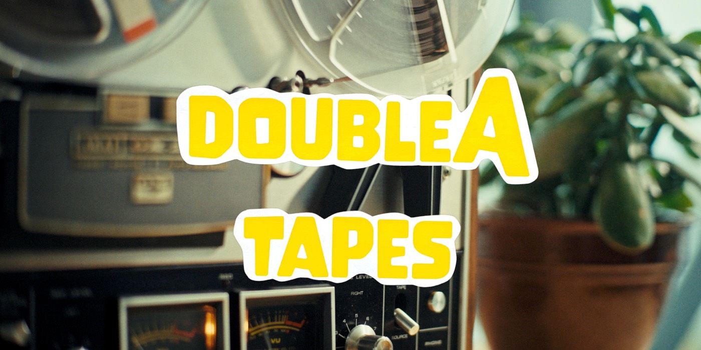 The title doubleA tapes over an old reel-to-reel tape recorder